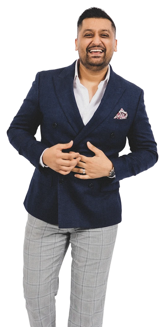 DJ Ambo Magic smiling in a navy double-breasted suit